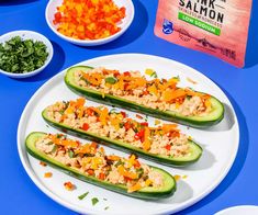 stuffed cucumbers with tuna and vegetables on a blue table