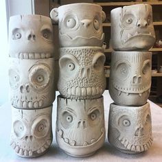 several white vases are stacked on top of each other in the shape of monsters