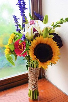 a vase filled with lots of different types of flowers