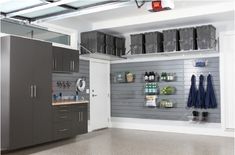 an organized garage with gray cabinets and shelves