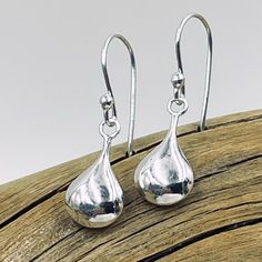 Delicate sterling silver puffed teardrop shines from sterling silver earring wires. Teardrop measures approximately 16mm x 8mm Silver Teardrop Earrings With Polished Finish For Gift, Sterling Silver Long Drop Teardrop Earrings For Formal Occasions, Silver Teardrop Crown Earrings For Pierced Ears, Silver Teardrop Earrings With Polished Finish, Classic Silver Teardrop Earrings Gift, Silver Long Drop Teardrop Earrings, Silver Teardrop Crown Earrings For Formal Occasions, Silver Teardrop Crown Earrings For Formal Events, Silver Pear-shaped Earrings With Polished Finish