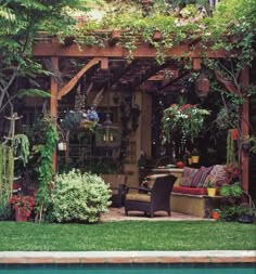 an outdoor living area with lots of plants