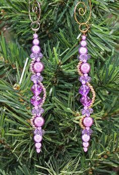 purple beaded earrings hanging from a tree