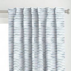 a white curtain with blue waves on it