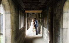 a bride and groom are standing in an archway at the end of their wedding day