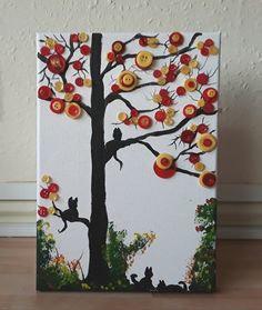 a painting with buttons on the tree and cats sitting in the branches, all around it