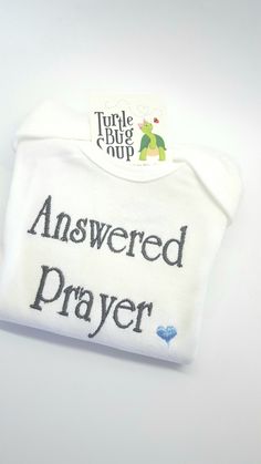 Answered Prayer newborn cotton crossover shirt or romper is perfect for the hospital and all those first photo ops. This shirt is adorable for baby shower gifts, adoption gifts and hospital gifts for the new parents. Add a personalized hat for the perfect outfit! https://www.etsy.com/listing/562195188/personalized-baby-boy-hat-baby-name?ref=shop_home_active_2 https://www.etsy.com/listing/565645457/personalized-newborn-hat-newborn-hat?ref=shop_home_active_4 https://www.etsy.com/listing/490933392/ Cotton Baptism Onesie With Short Sleeves, Cute Cotton Onesie For Baptism, White Short Sleeve Onesie For Baptism, Personalized Cotton Onesie For Gender Reveal, Personalized Cotton Onesie For Baptism, Personalized Short Sleeve Onesie For Gift, Personalized Short Sleeve Onesie As Gift, Gift Custom Print Short Sleeve Onesie, Newborn Boy Hats