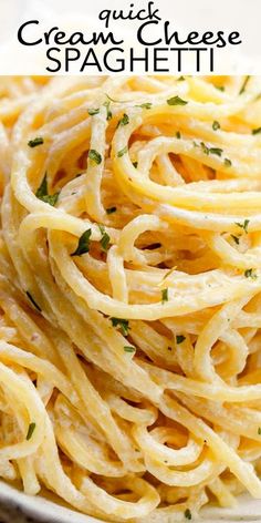 a white bowl filled with pasta and topped with parsley