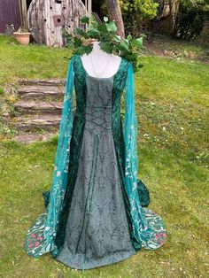 THIS STUNNING ENCHANTED ORIGINAL HAND CRAFTED DRESS HAS BEEN  FASHIONED  IN THE PRINCESS LINE STYLE   IT IS MADE FROM IN A LUXURIOUS TRULY GORGEOUS DARK HUNTER'S  GREEN CRUSHED VELVET  (CONTAINING LYRCA) ...   THE STUNNING FLOOR LENGTH MEDIEVAL STYLE SLEEVES HAVE BEEN FASHIONED  FROM  A LUXURIOUS TRULY GORGEOUS AND UNIQUE WOODLAND TEAL STUNNING EMBROIDERED TULLE WITH A BEAUTIFUL FLOWER MEADOW DESIGN WORTHY OF WOODLAND KIN, FOR THAT EXTRA TOUCH OF ELEGANCE   IDEAL FOR  A  MEDIEVAL / RENAISSANCE T Celtic Otherworld, Celtic Handfasting, Handfasting Wedding, Boho Gown, May Queen, Princess Line, Gothic Wedding Dress, Dark Hunter, Flower Meadow