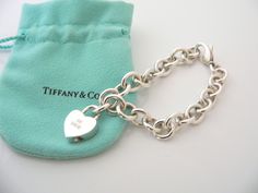 Offered for sale is a gorgeous and super awesome Tiffany and Co. Silver BE MINE Heart padlock bracelet. Wonderful and very contemporary bracelet that fits a lifestyle on the go -- this piece can be worn to almost any occasion! Imagine the piece with your professional office attire ... Now imagine it with a little black dress ... One last, imagine it with jeans or a really cute sundress ... Perfect in every way! The item is versatile, very comfortable to wear, and is in excellent condition. The " Padlock Bracelet, Contemporary Bracelets, Cute Sundress, Heart Padlocks, Professional Office, Tiffany And Co, Office Attire, Gift Pouch, Be Mine