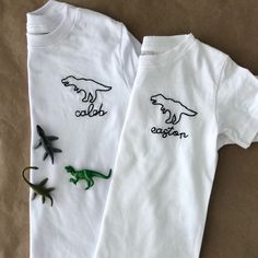 The sweetest hand embroider tee for the little Dino lover in your life. Shirt Details: 100% combed ring spun cotton fine jersey Please size up if you are in between sizes as shirts will shrink after wash/dry Size chart in images to reference Any questions - please message me. Returns and Exchanges: I do not accept returns on personalized pieces but will be happy to discuss any issues via messages. Thanks for visiting Sweet Olive Street! Check us out on Instagram for more behind the scenes - @swe White Family Matching T-shirt With Embroidered Text, Family Matching White T-shirt With Embroidered Text, White Embroidered T-shirt For Family Matching, Cute T-shirt With Machine Embroidery And Short Sleeves, Cute Fitted Tops With Custom Embroidery, Cute Fitted Top With Custom Embroidery, Casual Fitted Top With Custom Embroidery, Cute White T-shirt With Machine Embroidery, Cotton T-shirt With Machine Embroidery, Relaxed Fit