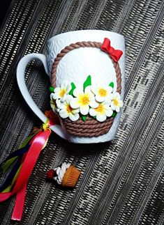 a coffee cup decorated with flowers and ribbon