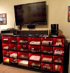 two pictures of a living room with various items on the shelves and a television in the corner