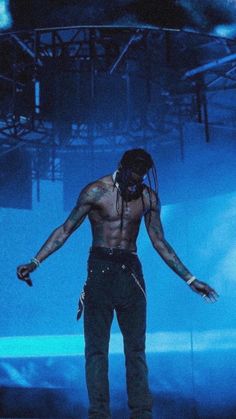 a man with dreadlocks standing on stage