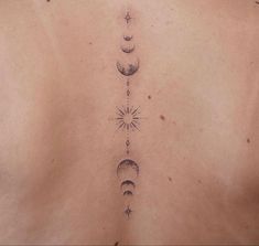 a woman's back with three phases of the moon tattoo on it