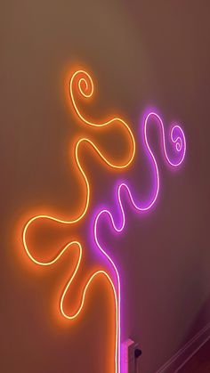 a neon sign that is on the side of a wall