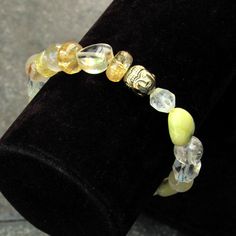 Women's Size 7" stretch bracelet A. Citrine Hearts, Citrine roundels , Rutilated gold, Hematite Buddhas, mixed Tourmaline Hearts, Yellow Calcite, Smoky topaz, and yellow Jasper. B. Citrine hearts, clear quartz, Jasper Hearts, Hematite Buddhas, Rutilated Gold, Citrine Roundels, Rutilated gold roundels, and citrine Star cut Our gemstone bracelets are all original designs by Lisa Beth and LDE Affinity Jewelry. They are hand crafted with passion and love in our Southern California studio. The beads Yellow Jasper, Golden Buddha, Yellow Calcite, Smoky Topaz, Citrine Gemstone, Jasper Gemstone, Gemstone Bracelets, Stretch Bracelet, Clear Quartz