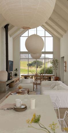 a living room filled with furniture and a fire place in front of a large window