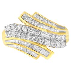 Elegant and timeless, this 10K yellow gold diamond statement ring features 1.0 carat total weight of diamonds with 64 individual stones. The bypass style fashion ring features a two row wave of round, brilliant cut diamonds in shared prong settings centered between two bypass style ribbons of channel set baguette cut diamonds on each side. The ring has a peekaboo open gallery and a tapered, flat-style shank with a polished finish. This classic cocktail ring makes a great gift for any special occ Channel Set Rings, Statement Rings Diamond, Bracelet Love, Bypass Ring, Baguette Cut Diamond, Gold Ribbons, Channel Set, Anniversary Bands, Baguette Cut