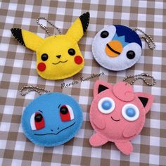 four different pokemon key chains on a table