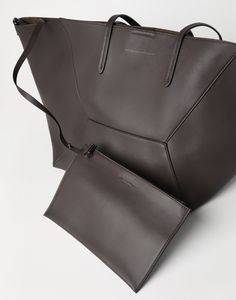 BC Duo bag in calfskin with monili The calfskin BC Duo bag reinterprets the classic "everyday bag" in true Brunello Cucinelli style. With an ultra-soft hand, the leather enhances the accessory’s contemporary feel, highlighted by bold stitching that emphasizes the squared, minimal lines. A removable internal zipper pouch and the practical magnetic closure complete the style, while two monili embroideries add a feminine, sparkling note. If fastened, the internal ties on the sides allow the shape o Sleek Formal Bags With Leather Handles, Formal Sleek Bags With Leather Handles, Sleek Leather Bags With Soft Leather, Luxury Everyday Bag With Smooth Grain, Sleek Calf Leather Shoulder Bag For Everyday Use, Sleek Soft Leather Bag, Calf Leather Shoulder Bag With Palladium Hardware, Sleek Leather Shoulder Bag With Palladium Hardware, Sleek Calf Leather Bag With Leather Lining