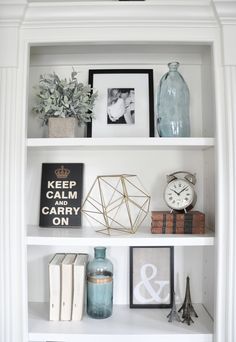 a white book shelf with pictures and other items on top of it, along with the words styling built - in