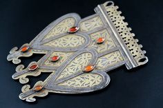 This remarkable antique Turkmen (Turkoman) triple-asyk pendant was handcrafted in silver during the late 1800's or early 1900's for the Teke (Tekke) sub-tribe of Turkmenistan, Central Asia. It is very-old, collectible Turkmen tribal jewelry - not a new reproduction. MEASUREMENTS (1 inch = 2.54 cm): Size = 7 inches long x 5-1/2 inches wide Weight = 10.1 oz (286 grams) Shipping Weight = 16 oz TM image library 4-1-2022 Distinctively Turkmen, asyk (asik) pendants were given to women as engagement an Traditional Medallion Jewelry With Historical Design, Traditional Wedding Necklace With Historical Design, Traditional Pendant Necklace With Historical Design, Traditional Necklaces With Historical Design, Traditional Necklace With Historical Design As Gift, Traditional Necklace With Historical Design For Gift, Traditional Necklaces With Historical Design For Gift, Traditional Jewelry With Historical Design For Ceremonial Use, Mount Dora