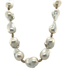 This impressive necklace features 19 large white baroque freshwater nucleated pearls ranging in size from 14 to 16mm! They have beautiful white and silvery-white pearlescence and have been hand strung on silk thread with 14k white and yellow gold spacers. A single 9.50mm round, white freshwater pearl accents each end, and the necklace has been finished with a beautiful white gold clasp. A contemporary look that will complement both your casual and dressy wardrobe, you can't go wrong with pearls! White High Luster Round Beaded Necklaces, White High Luster Round Bead Necklaces, White Baroque Necklace For Formal Occasions, White Akoya Pearl Necklace In Pear Shape, Luxury White Necklaces With Polished Beads, High Luster Baroque Pearl Necklace For Formal Occasions, White Pearl Charm Necklace In Pear Shape, White Baroque Pearl Necklace For Formal Occasions, White High Luster Pearl Necklaces