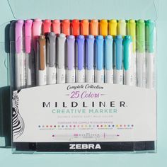 a box of zebra colored marker pens with the packaging on it's back side