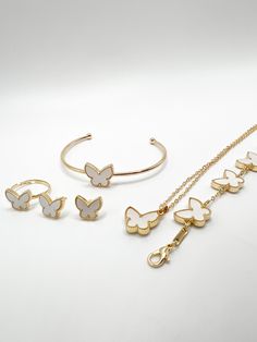 This beautiful butterfly jewelry set features a necklace, ring, earrings, and two bracelets that showcase the delicate and intricate design of butterflies. The necklace features a dainty butterfly pendant with sparkling crystal wings, suspended from a slender chain. The ring is adorned with a butterfly-shaped gemstone surrounded by tiny details that resemble the butterfly's body and antennae. The earrings are designed to resemble a pair of butterflies perched on the earlobe, with delicate wings Adjustable Rose Gold Jewelry With Butterfly Charm, Rose Gold Adjustable Jewelry With Butterfly Charm, Elegant Butterfly Jewelry Gift For Her, Elegant Butterfly Jewelry As A Gift For Her, Butterfly Shaped Rose Gold Jewelry For Gifts, Butterfly Shaped Rose Gold Jewelry Gift, Rose Gold Butterfly Jewelry For Gifts, Rose Gold Butterfly Jewelry Gift, Rose Gold Butterfly Charm Jewelry As Gift