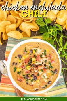 a bowl of chicken enchilada chili with tortilla chips in the background