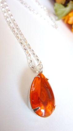 "Orange Necklace - Hyacinth Orange Pendant - Crystal Drop Necklace - Bridesmaids Bridal Necklace I have attached these gorgeous clear deep teardrop hyacinth orange jewels to silver settings and hung them from a pretty silver boxchain. The shimmering jewels are 18x13 mm. They shine with a timeless beauty and would go with a wedding outfit, prom, bridesmaid or can be worn on your special day. The necklace is 16 1/2\" and the pendant hangs another 1\" below the chain. Matching earrings are availabl Orange Necklace, Orange Earrings, Crystal Drop, Bridal Necklace, Drop Necklace, Matching Earrings, Wedding Outfit, Timeless Beauty, Dangle Drop Earrings