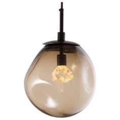 a light that is hanging from a ceiling fixture with a glass ball in the middle