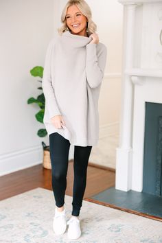 This wide mock neck tunic is the exact point at which style and comfort meet! The length is perfect for pairing with leggings which only adds to the comfort. We also love that you can dress this look up or down by pairing with boots/booties or sneakers depending on what your day looks like! Wide mock neckline Long sleeves with drop shoulders Ribbed fabric Oversized fit Fair stretch Payton is wearing the small. Oversized Tunic Sweatshirt Outfit, Slouchy Boots Leggings, Oversized Cozy Sweatshirt With Funnel Neck, Grey Tunic Sweater, Mid-rise Stretch Leggings With Pull-on Style, Fall Comfort Stretch Leggings With Pull-on Style, Maternity Tunic Tops With Leggings, Mock Neckline, Long Shirt