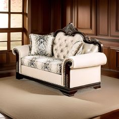 a living room with a couch and rug in front of a wooden paneled wall