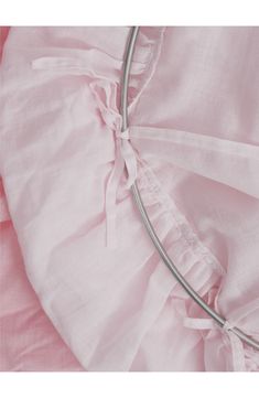 a close up of a pink dress with a metal hoop on it's side