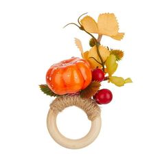 a wooden ring with fruit and leaves on it's sides, sitting in front of a white background