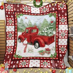 an old red truck with christmas decorations on it's bed is displayed in front of a wall hanging