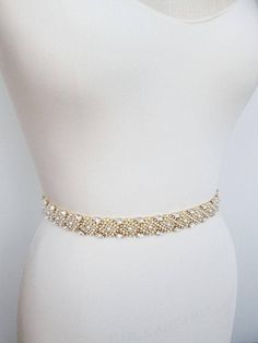 "This pearl and crystal belt is made with Swarovski crystals and is beaded on a sheer organza ribbon. The crystal beading measures 1\" wide and 27\" long. The entire sash measures 150\". Available in gold, silver or rose gold finish and with satin, organza or grosgrain ribbon. - The length of the beading can be customized, please inquire about the specific length and pricing" Gold Beaded Bridal Belt For Party, Elegant Gold Bridal Accessories With Sashes, Elegant White Belt With Rhinestones, Elegant Crystal Wedding Sashes, Elegant Gold Sashes With Embroidered Belt, Gold Embroidered Bridal Belt For Wedding, Elegant Embellished Crystal Bridal Belt, Elegant Rhinestone Party Sashes, Elegant Gold Belts