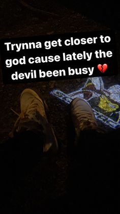 someone is standing in the dark with their feet up and there is a lit star on the ground