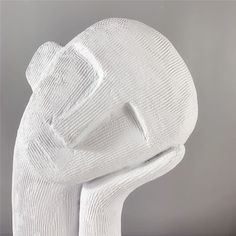 a white sculpture is sitting on a table