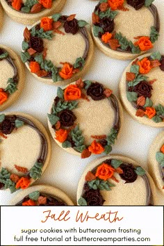 cookies decorated with buttercream frosting and flowers are arranged in the shape of a wreath