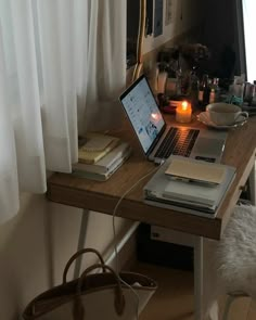 an open laptop computer sitting on top of a wooden desk next to a white chair