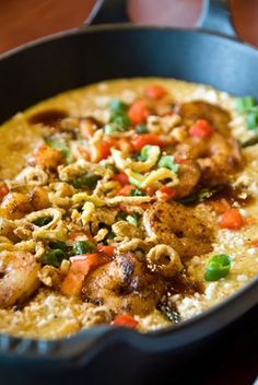 a pan filled with food on top of a wooden table