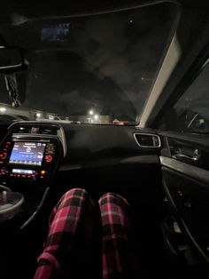 the interior of a car with its lights on and dashboard illuminated up at night time