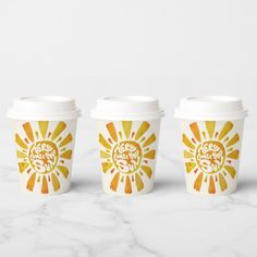 three coffee cups sitting next to each other on a marble counter top, with the words sunshine printed on them