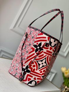 Part of the LV Crafty capsule collection for Fall 2020, the Neverfull MM tote bag looks stunning in Monogram Giant canvas with a bold geometric print inspired by the world of graffiti. Spacious and practical, the bag features sidelaces that can be tightened for a sleeker look or loosened for a more casual feel. Detailed Features 31 x 28 x 14 cm (Length x height x width ) Cream and Red Monogram Giant coated canvas Cowhide-leather trim Textile lining Gold-color hardware Leather side laces Snap hoo Giant Canvas, Ring Handle, Neverfull Mm, Capsule Collection, Sierra Leone, D Ring, Vuitton Handbags, Louis Vuitton Handbags, Luxury Boutique