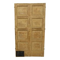 an old wooden door with a chalkboard on the front and side paneled doors