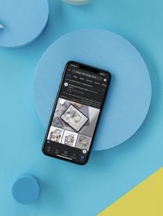 a cell phone sitting on top of a blue and yellow table with circles around it