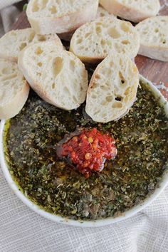 a bowl filled with bread and seasoning on top of a table